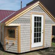12x24 Cross Gable modified post and beam cabin with tudor brown roof, specialty siding and custom windows and doors