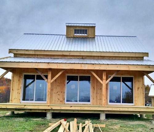 20x30 Vermont Cabin with 8x30 covered porch, custom cupola and client supplied sliding glass doors