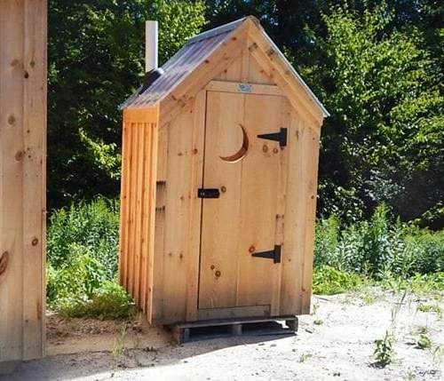 4x4 Working Outhouse with a clear roof and crescent moon cutout in the door