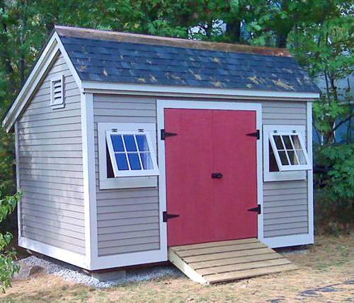 Painted 8x12 Church Street storage shed with red double doors and a pressure treated ramp